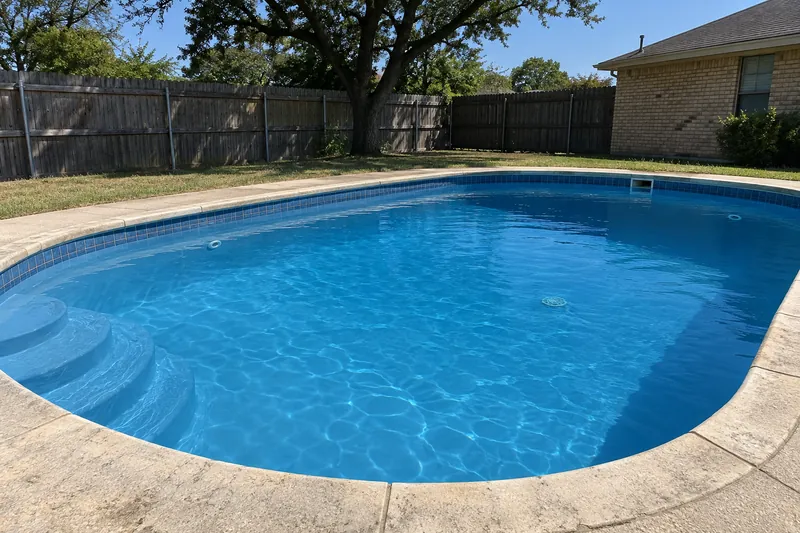 Backyard pool with a smooth blue painted finish under clear water