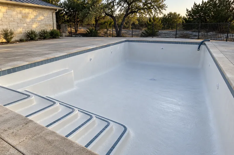 Drained community pool with a new white finish