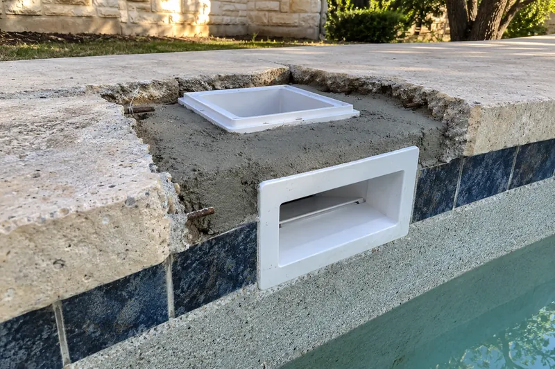 New skimmer body set in concrete at the pool wall