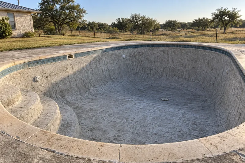 Old pool plaster chipped off to clean gunite, ready for new plaster