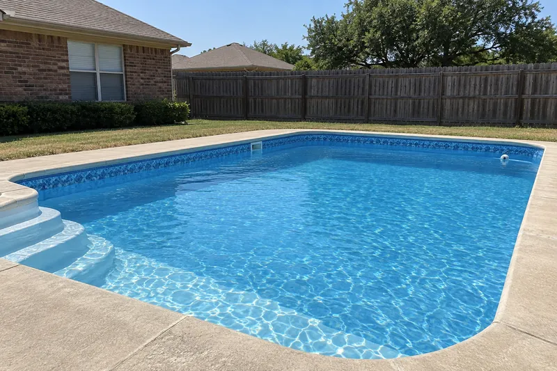In-ground vinyl liner pool with a printed tile border under the coping